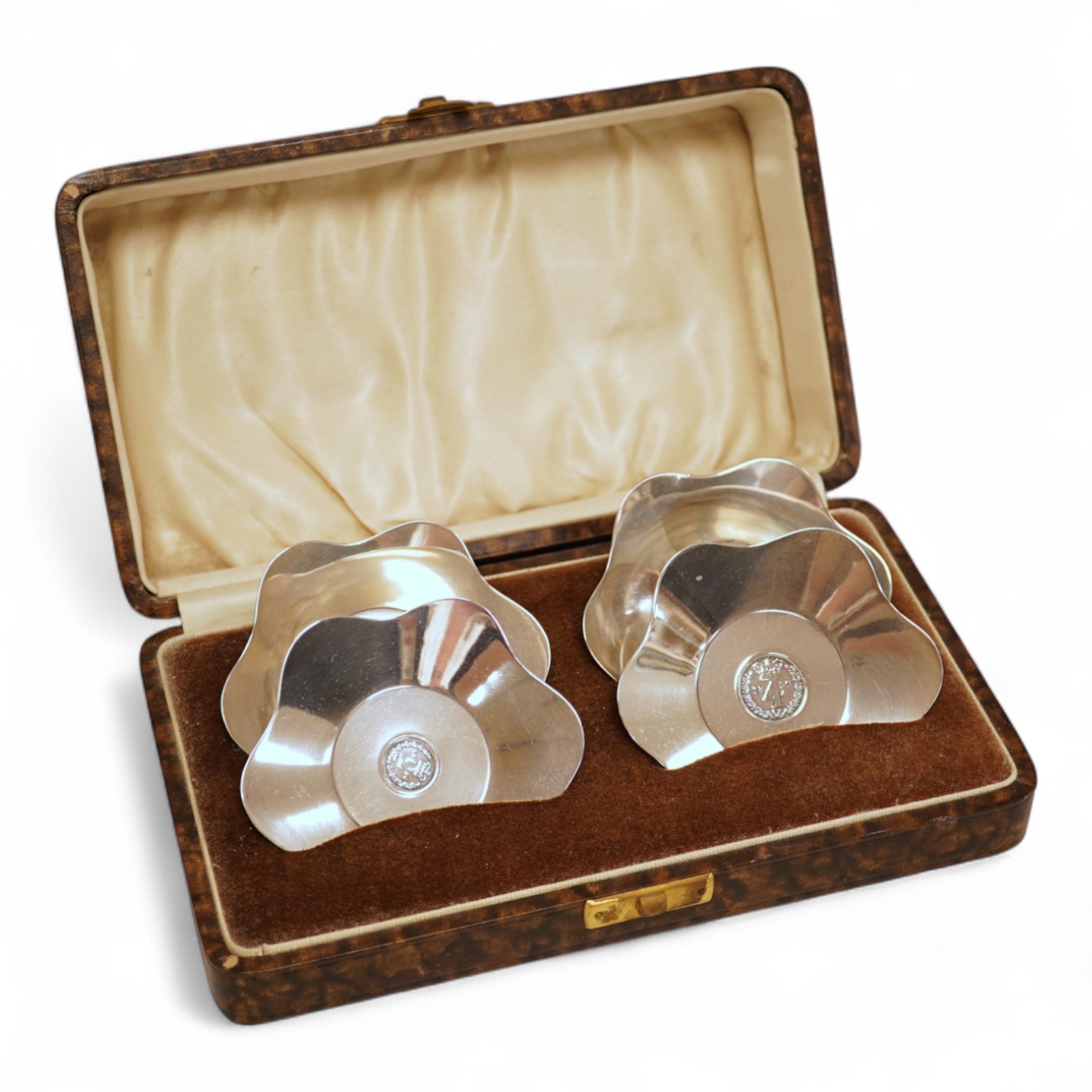A cased set of four George V silver flower head shaped nut dishes, each inset with an 1850 maundy coin, Walker & Hall, Birmingham, 1936, diameter 77mm.